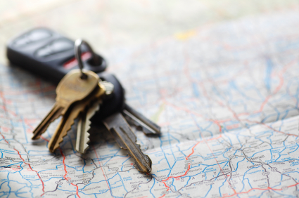 Car keys sitting on a map.