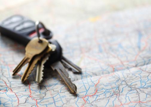 Car keys sitting on a map.