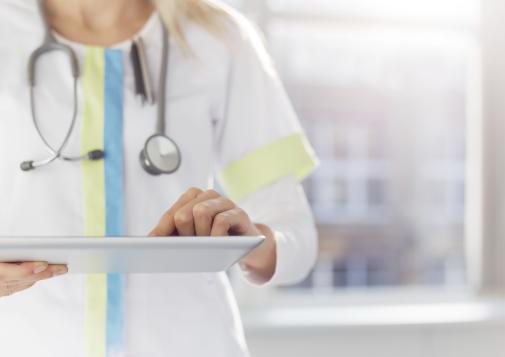 Healthcare provider holding a clipboard.