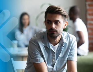 Man sitting on a couch looking away. 