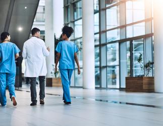 Health care providers walking in a hospital. 
