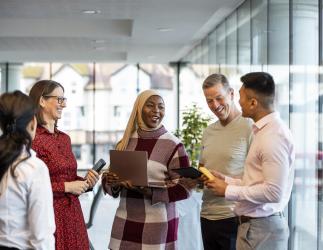 Group of employees talking at work.