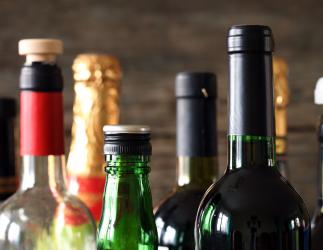 different types of alcohol bottles varying in size and colour 