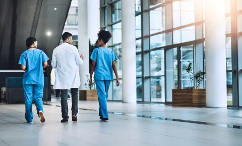 Health care providers walking in a hospital. 