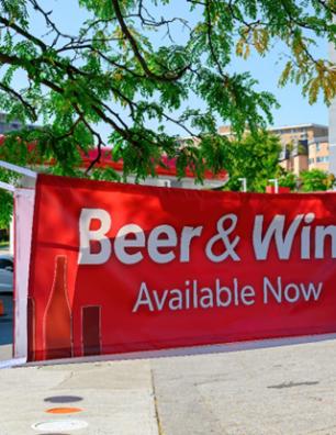 A public banner announcing beer and wine are now available.