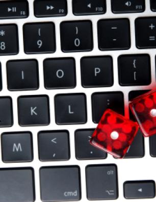 A pair of dice on a laptop keyboard.