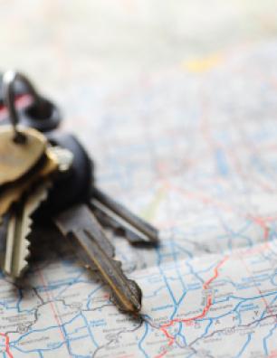 Car keys sitting on a map.