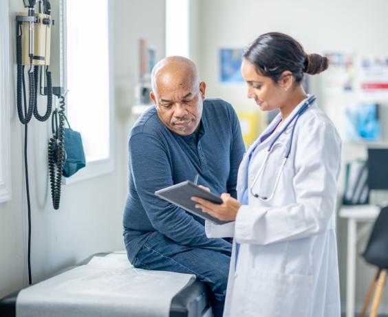 Physician discussing treatment plan with patient.