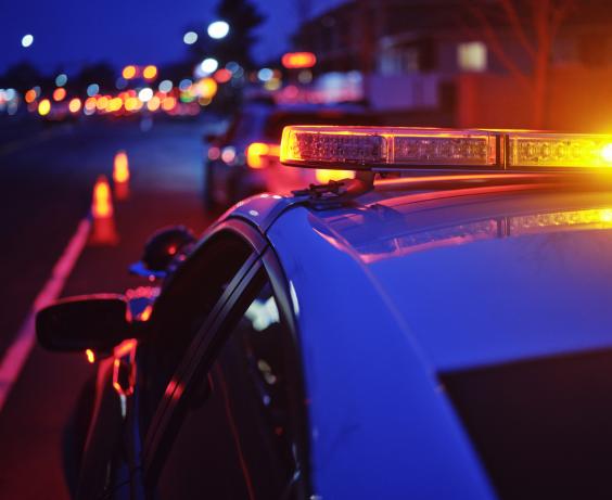 Police car pulled over behind a car.