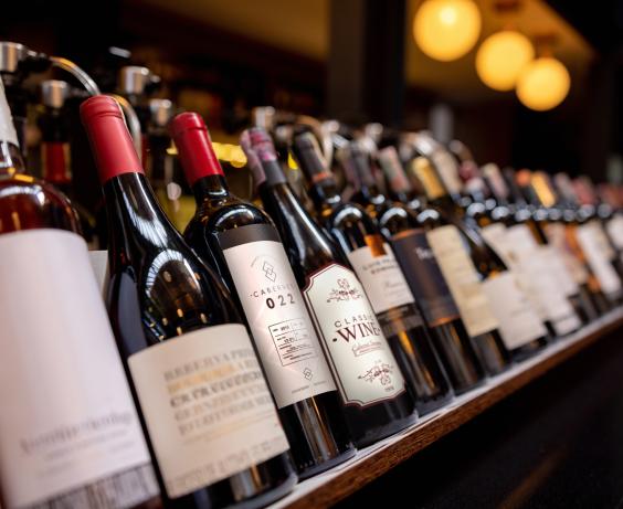 a series of wine bottles on a shelf